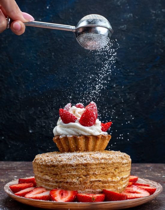 front-view-cake-slice-with-cream-fresh-red-strawberries-inside-plate-getting-sugar-powder-dark-background